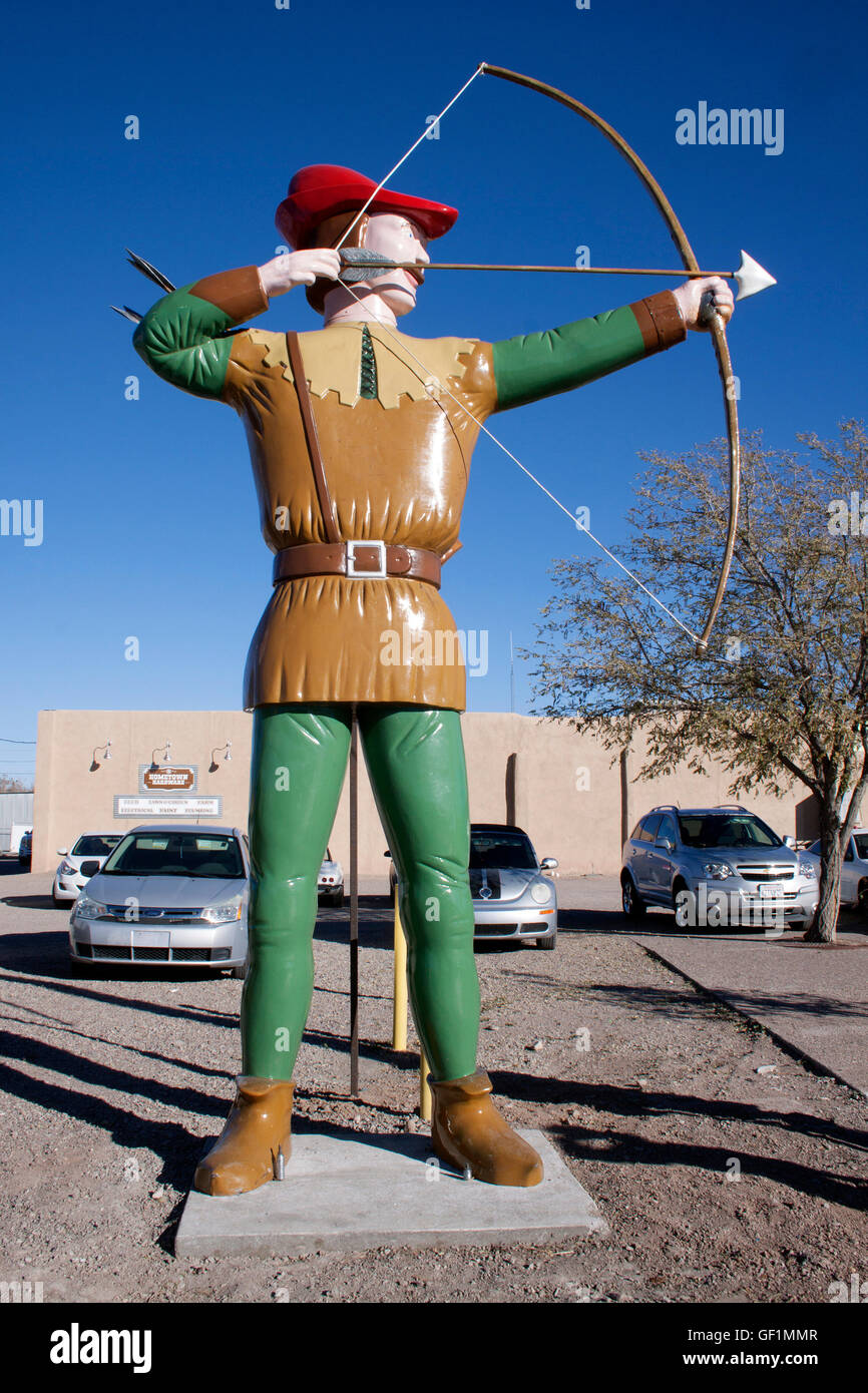 In Hatch, New Mexico, a robot with ice cream and a burger stands with a dinosaur and Robin Hood, creating a wild roadside restaurant scene. Stock Photo