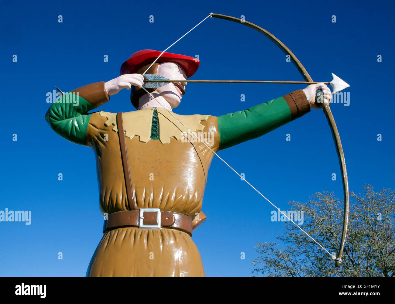 In Hatch, New Mexico, a robot with ice cream and a burger stands with a dinosaur and Robin Hood, creating a wild roadside restaurant scene. Stock Photo