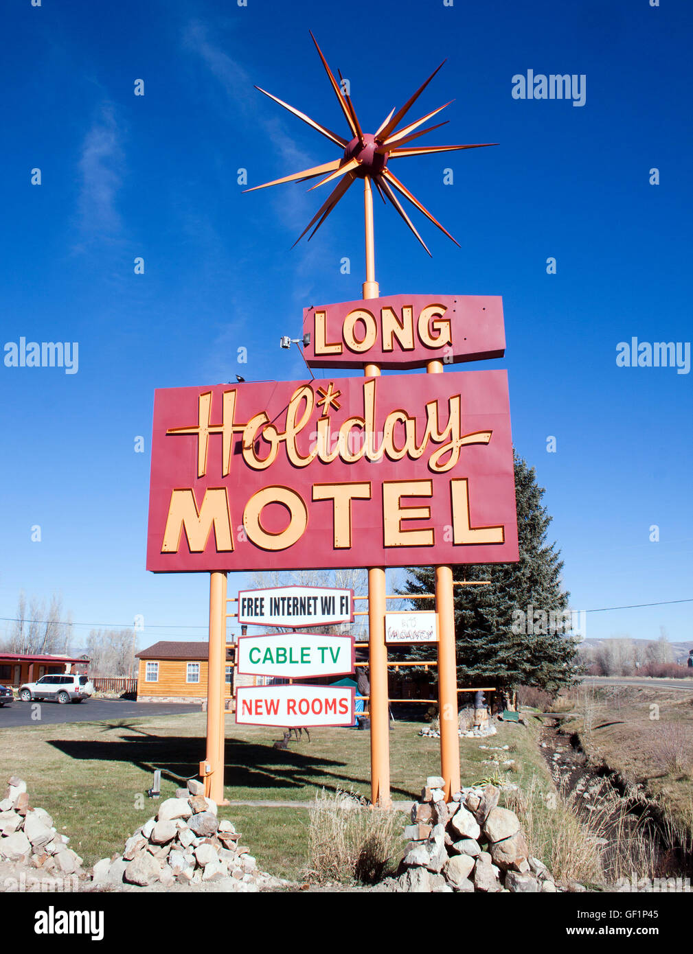 The retro Long Holiday Motel sign in Gunnison, Colorado, stands as a nostalgic roadside landmark along the scenic mountain town’s travel route. Stock Photo