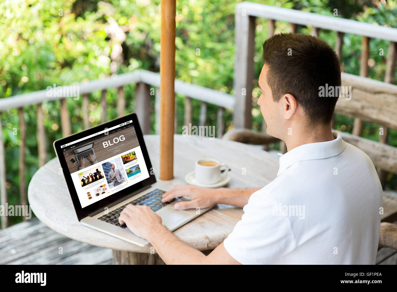 close up of man with laptop blogging on terrace Stock Photo