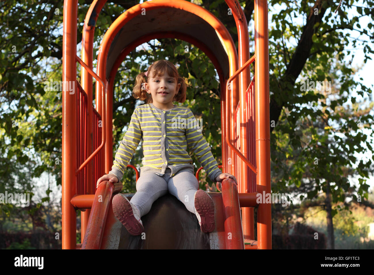 little girl on playground slide Stock Photo - Alamy