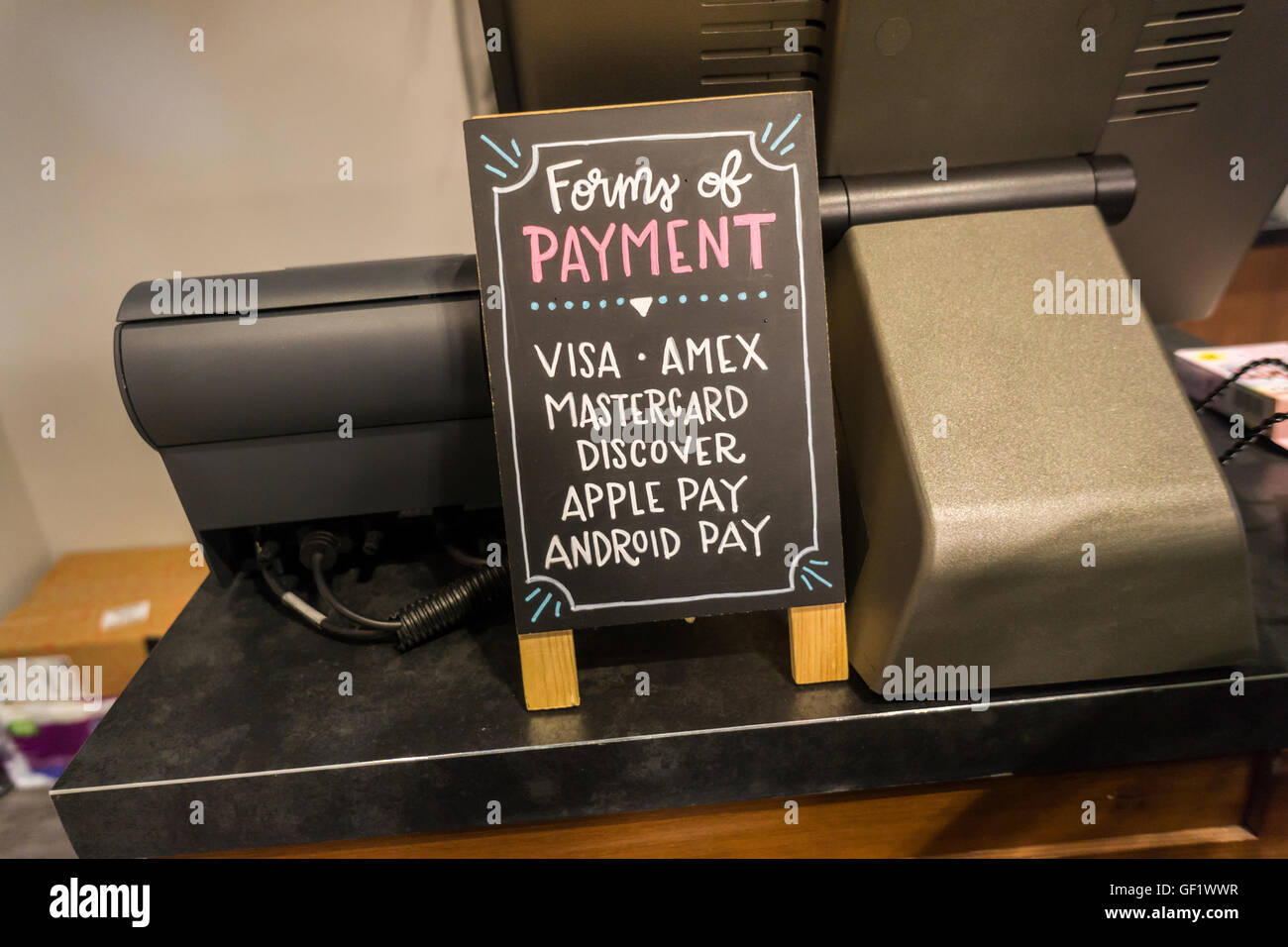 Pay Store Sign A sign near the cash register of a store in New York lets customers ...
