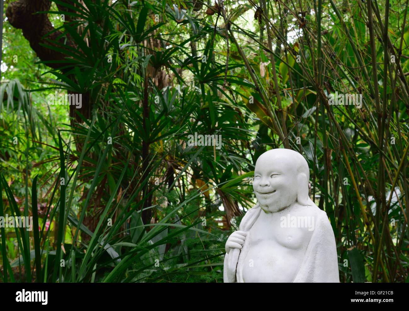 Profile of a Happy Buddha in Asian garden at Nature Coast Botanical Garden in Spring Hill, Florida. Stock Photo