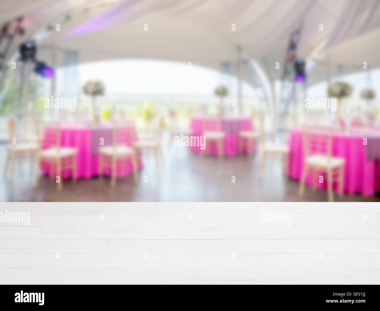 Wooden empty table in front of blurred restaurant Stock Photo - Alamy
