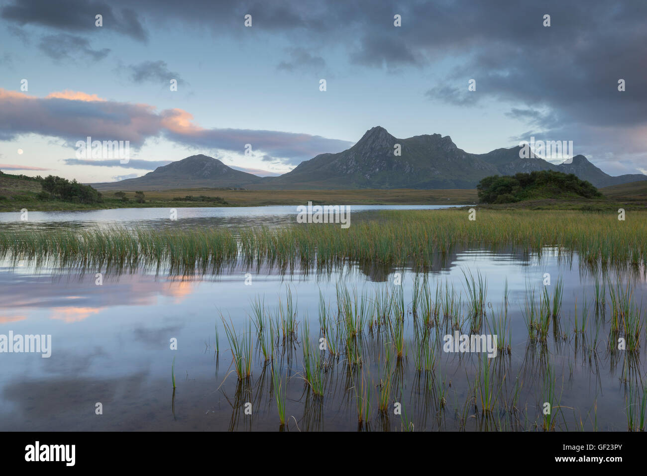 Ben Loyal mountain in Sutherland and Lochan Hakel just after sunset Stock Photo