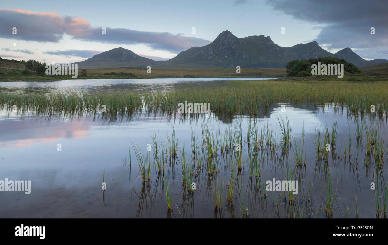 Ben Loyal mountain in Sutherland and Lochan Hakel just after sunset Stock Photo