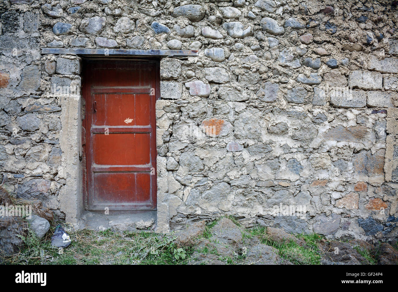 Ancient red wooden door in stone castle wall Stock Photo - Alamy