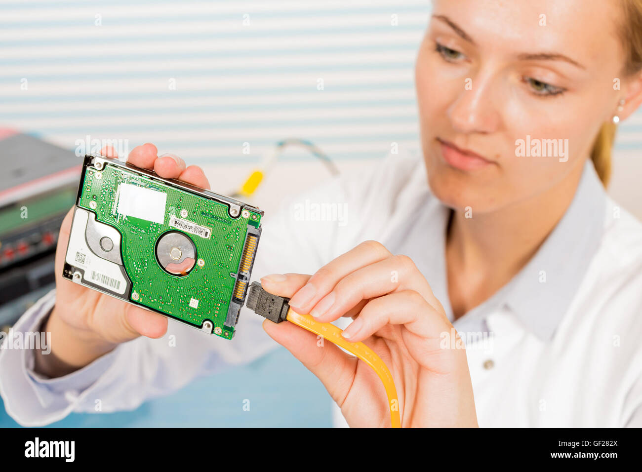 Electronics repair tech fixes curcuit board Stock Photo