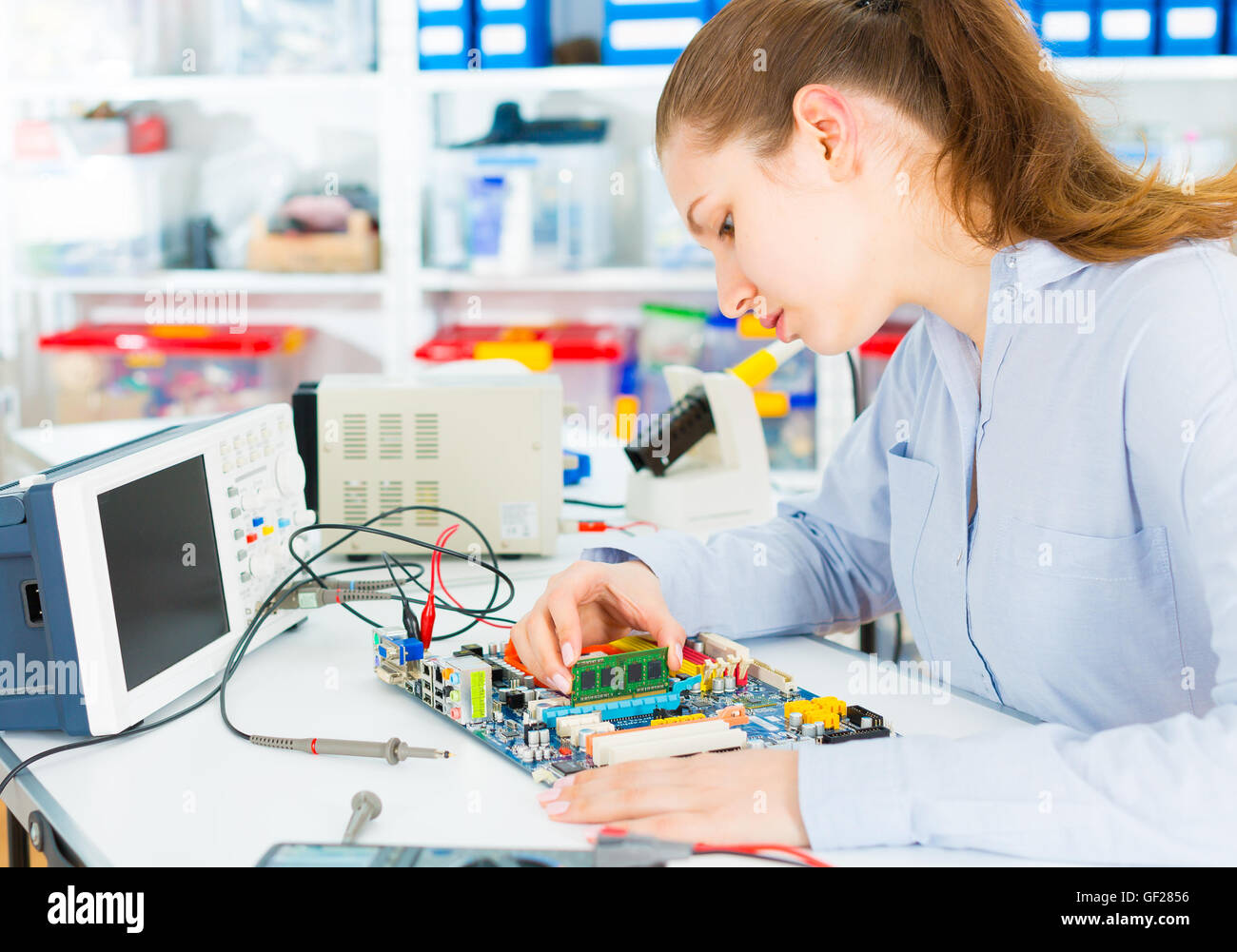 Electronics repair tech fixes curcuit board Stock Photo