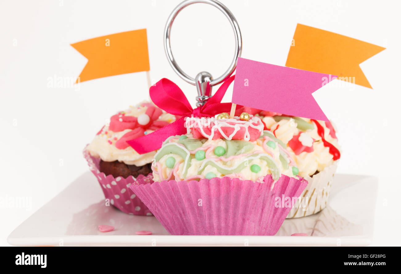 many sweet birthday cupcakes with flowers and butter cream Stock Photo