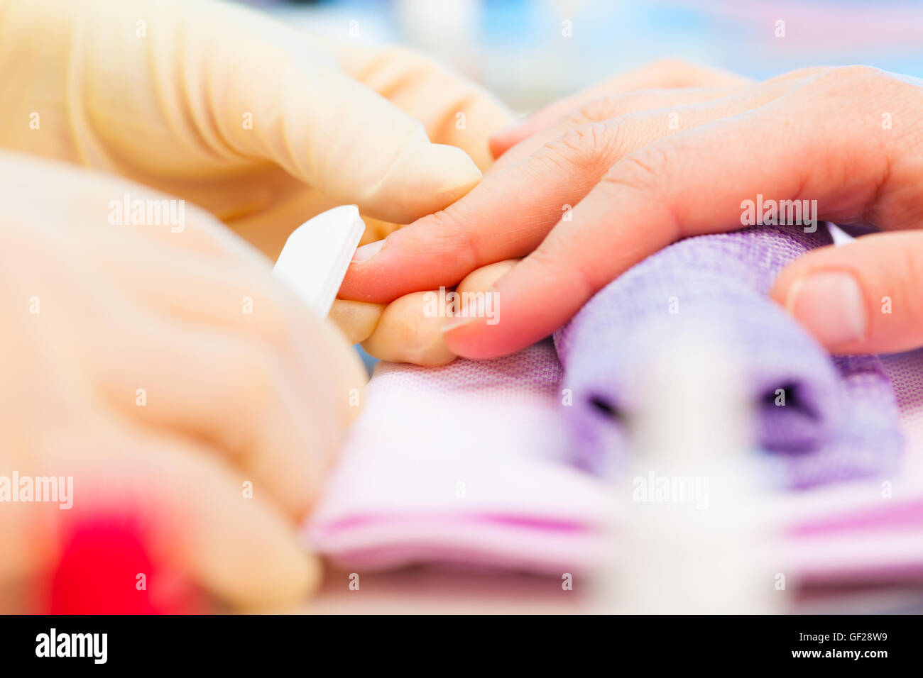 Young woman is getting manicure in a beauty salon Stock Photo