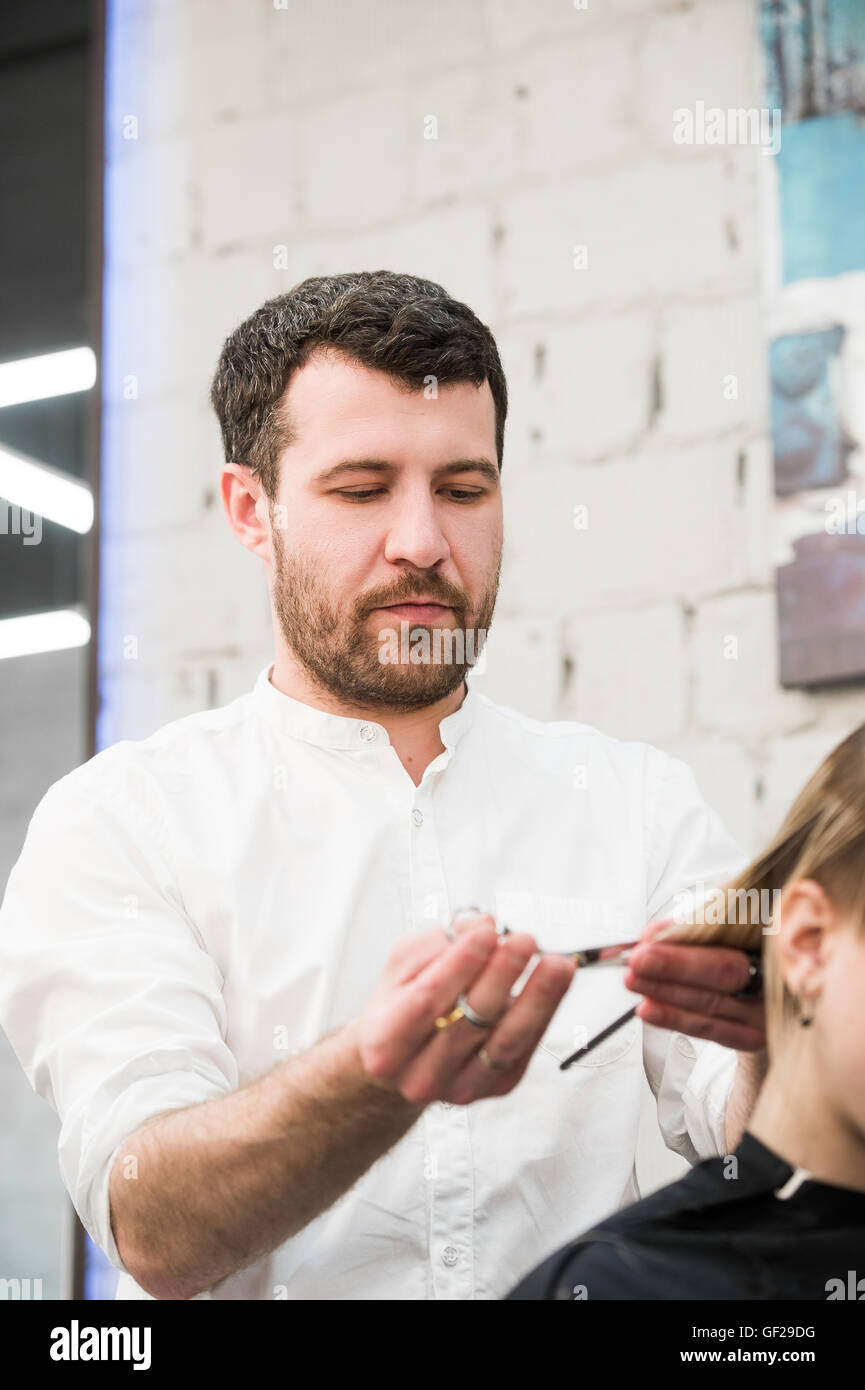 Male hairdresser making haircut for a client in professional hairdressing salon Stock Photo Alamy
