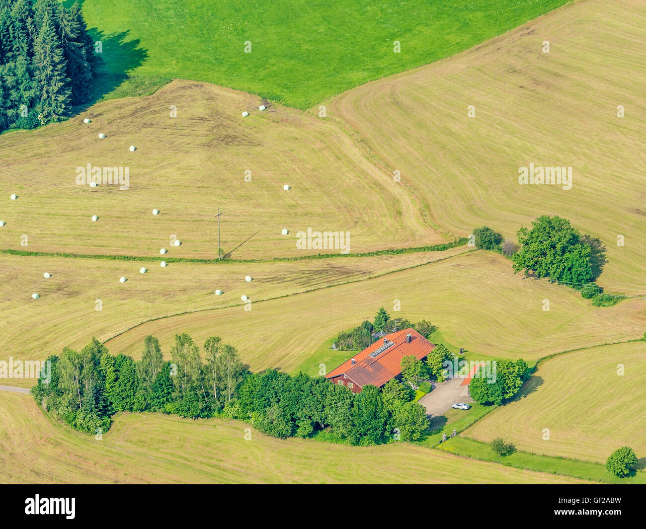 Lonely farm house surrounded by meadows, aerial view, slope of bavarian ...