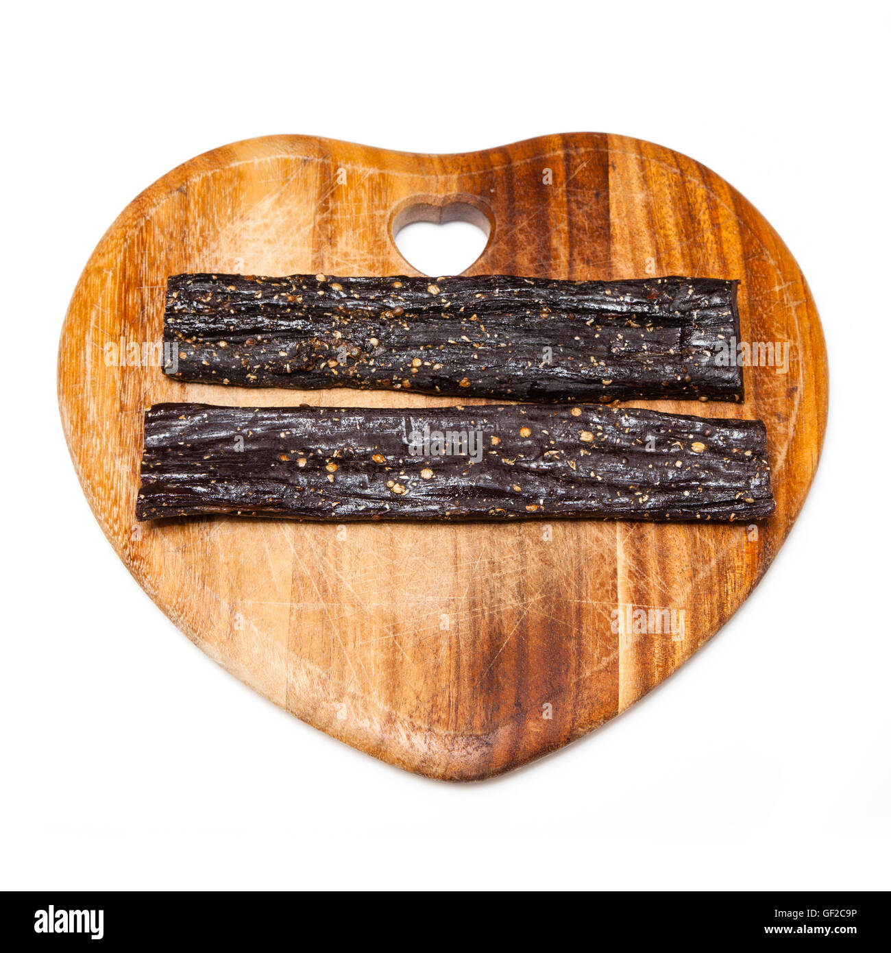 Beef Biltong , South African beef jerky on a wooden chopping board. Stock Photo