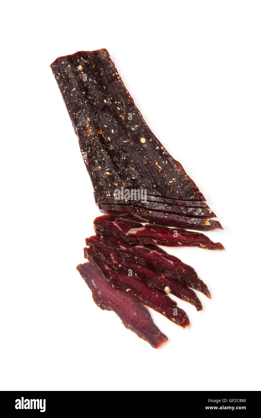 South African beef biltong or jerky whole and sliced isolated on a ...
