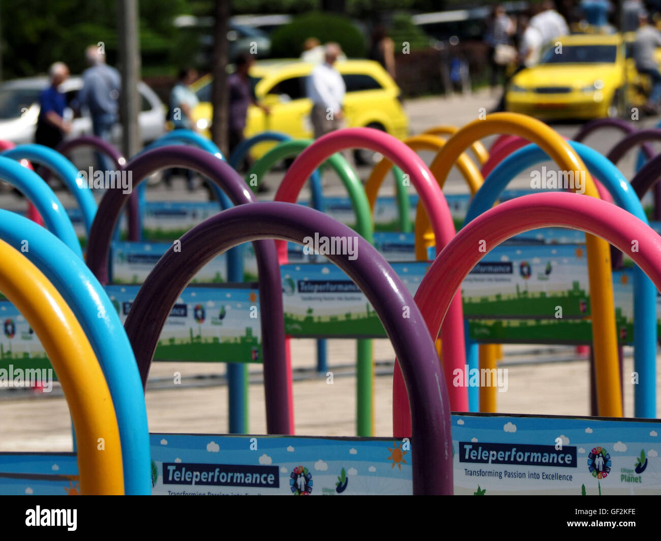 brightly coloured railings in city centre cycle park in busy Albanian ...
