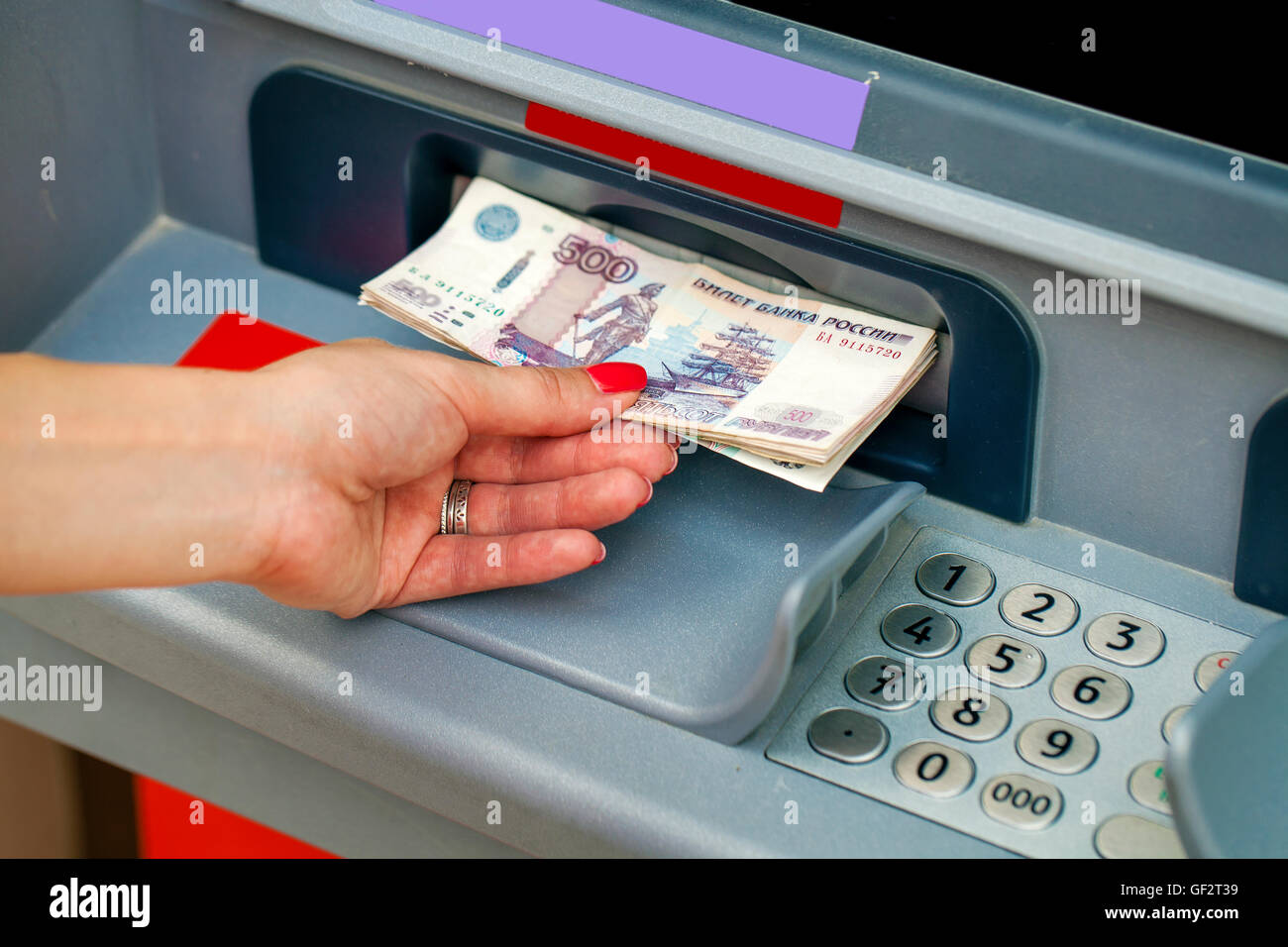 Female hands closeup with Russian rubles - woman withdraw money at cashpoints Stock Photo