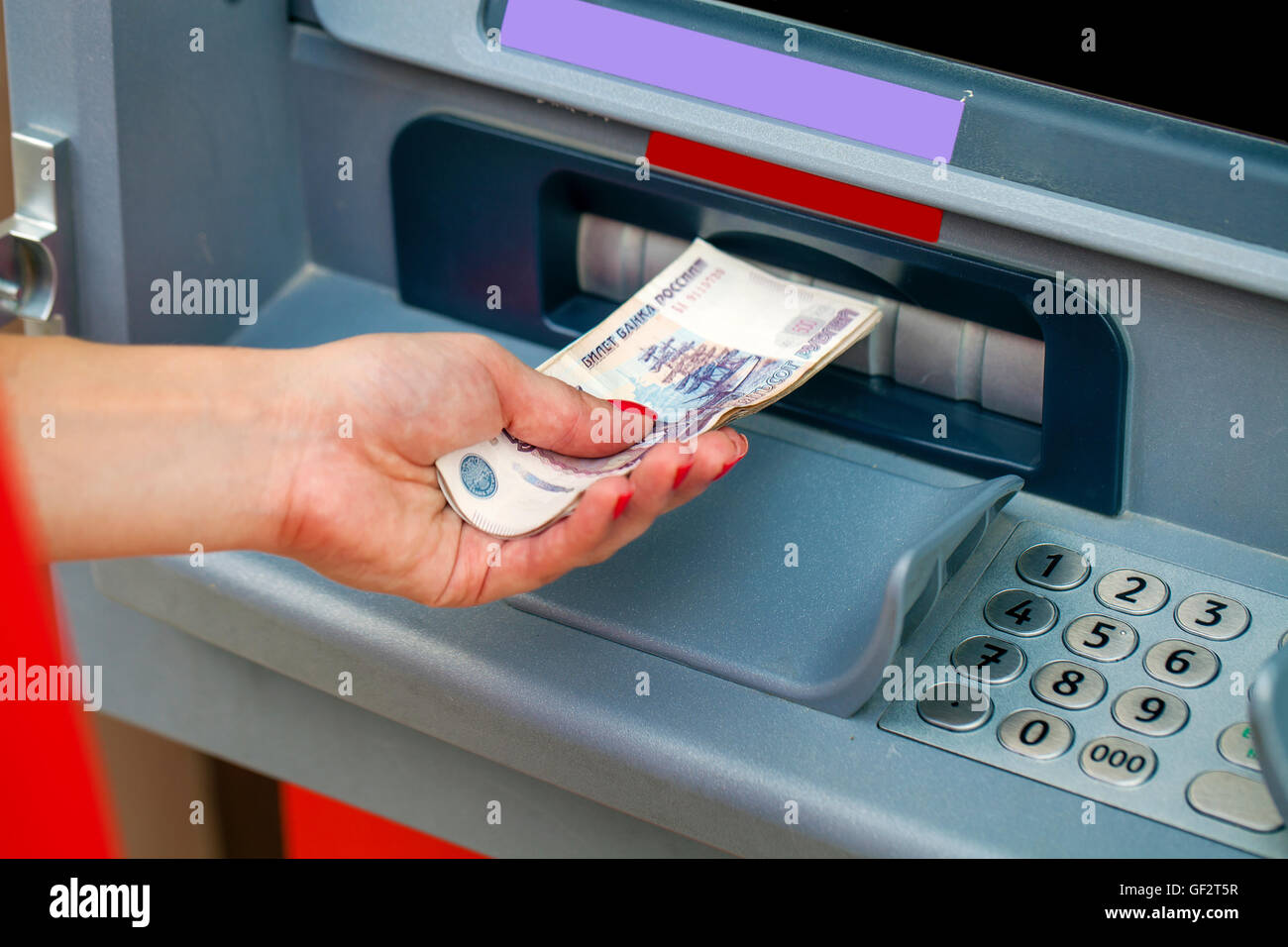 Female hands closeup with Russian rubles - woman withdraw money at cashpoints Stock Photo