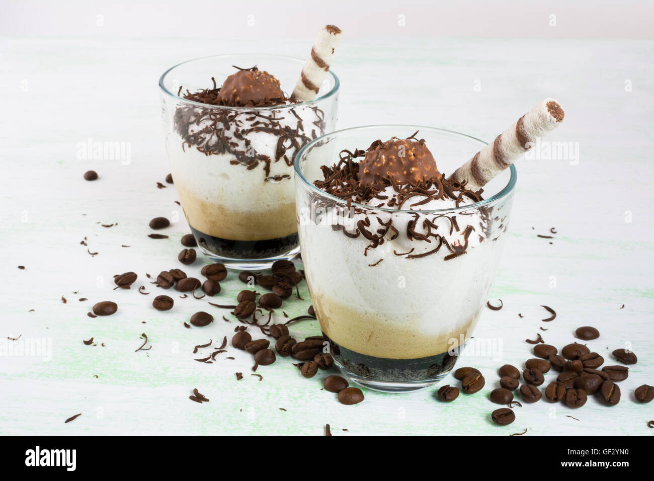 Chocolate cocktail with whipped cream on light green background. Coffee creamy dessert with chocolate. Stock Photo