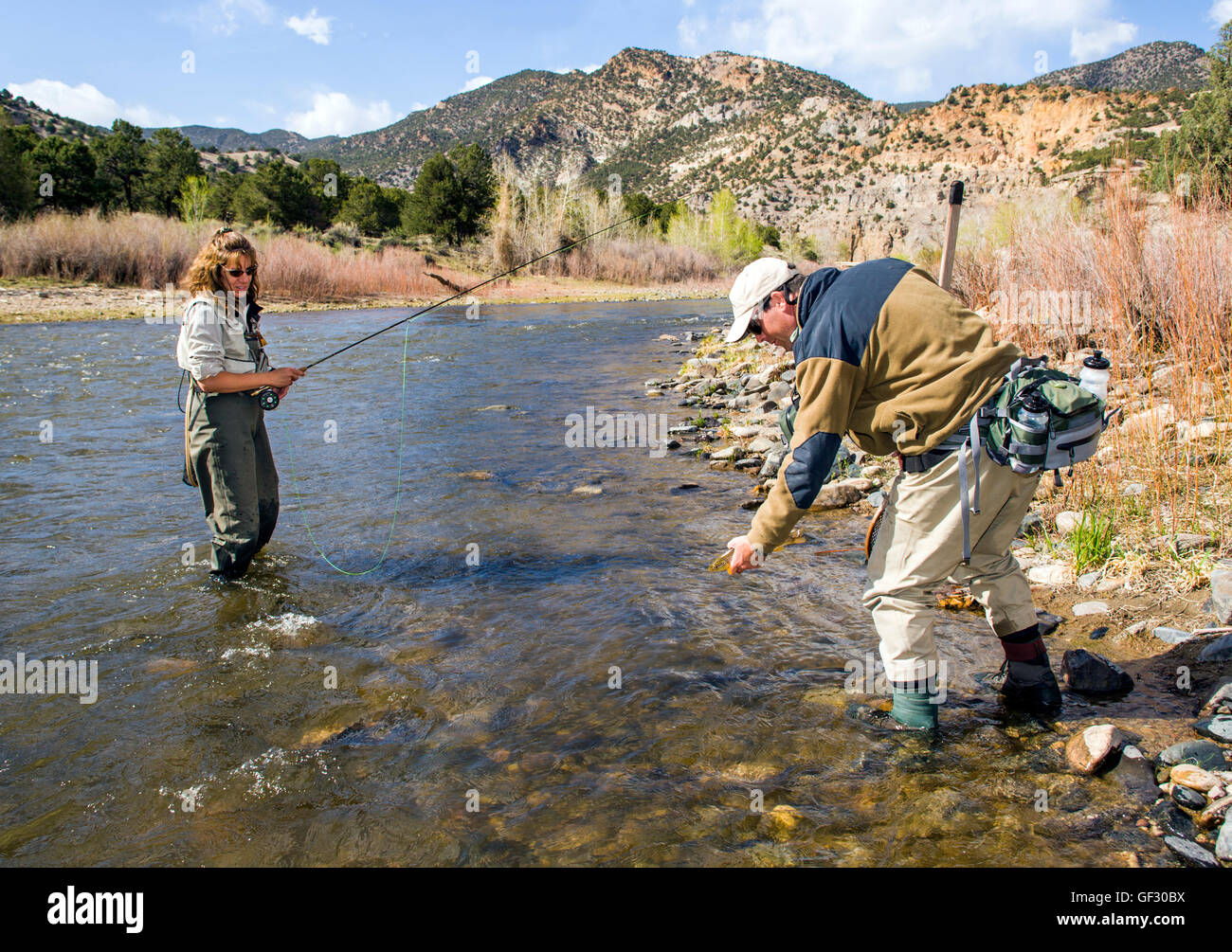 Male fly fishing guide with female client on the Arkansas River