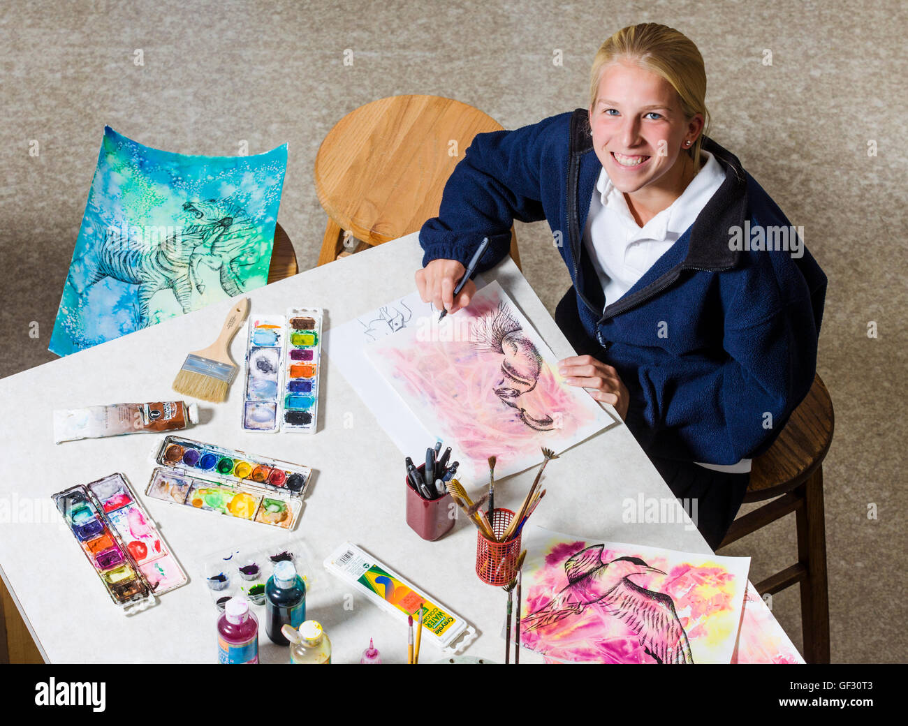 Smiling blonde haired female high school student in art class Stock ...
