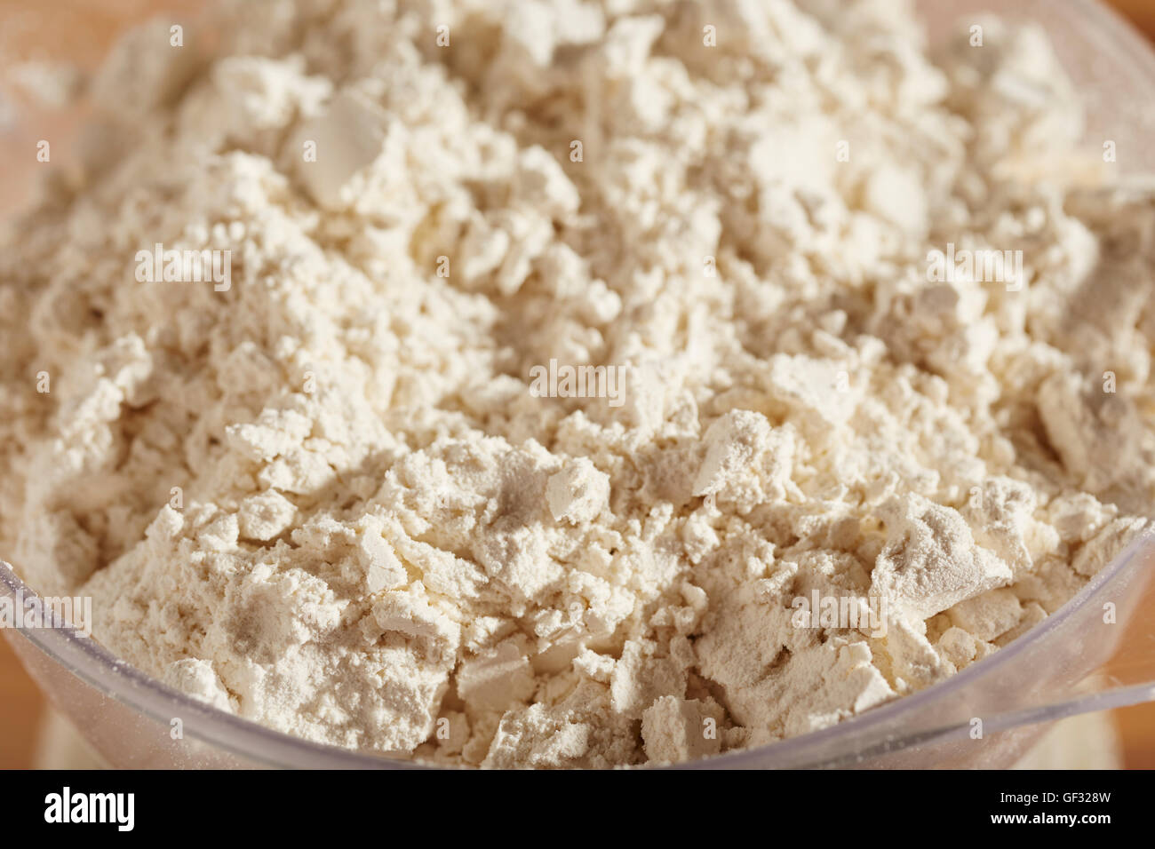 all purpose flour being weighed on a home kitchen scale Stock Photo