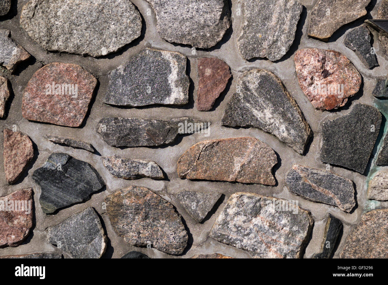 Variety of rock surfaces mortared into a memorial wall in Whitehall ...