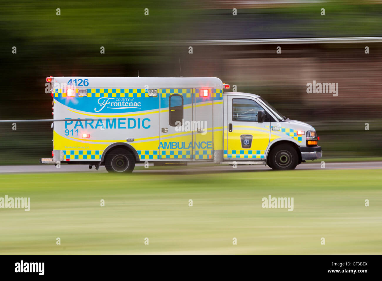 An ambulance drives with its sirens on in Kingston, Ont., on June 21 ...
