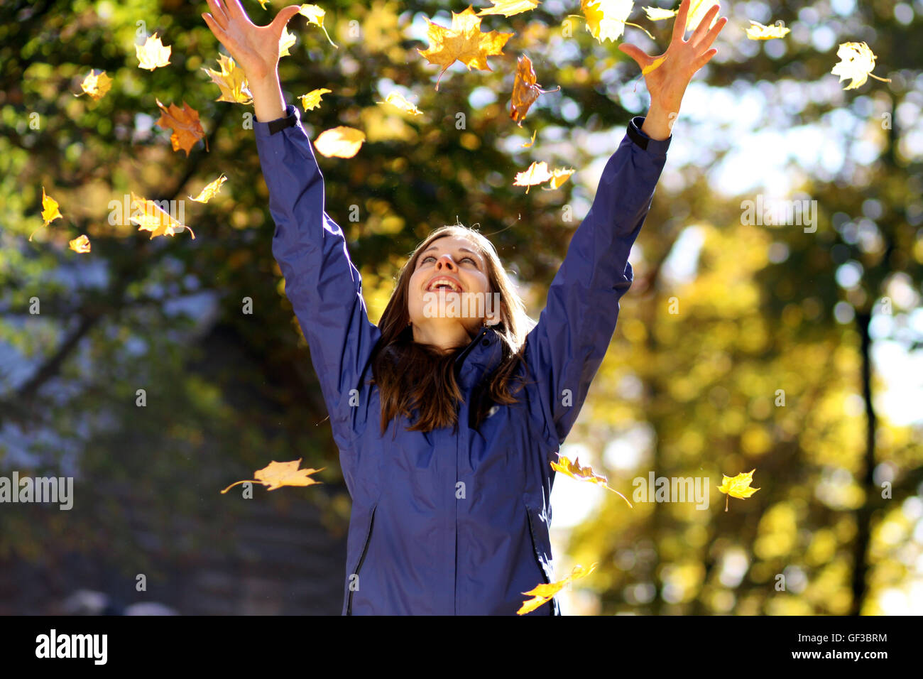 Beautiful young woman in autumn park Stock Photo - Alamy