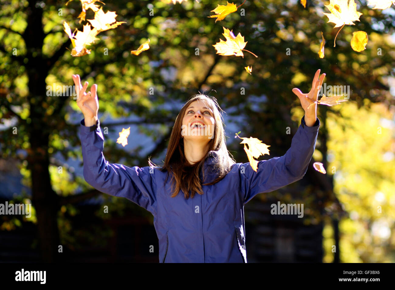 Beautiful young woman in autumn park Stock Photo - Alamy
