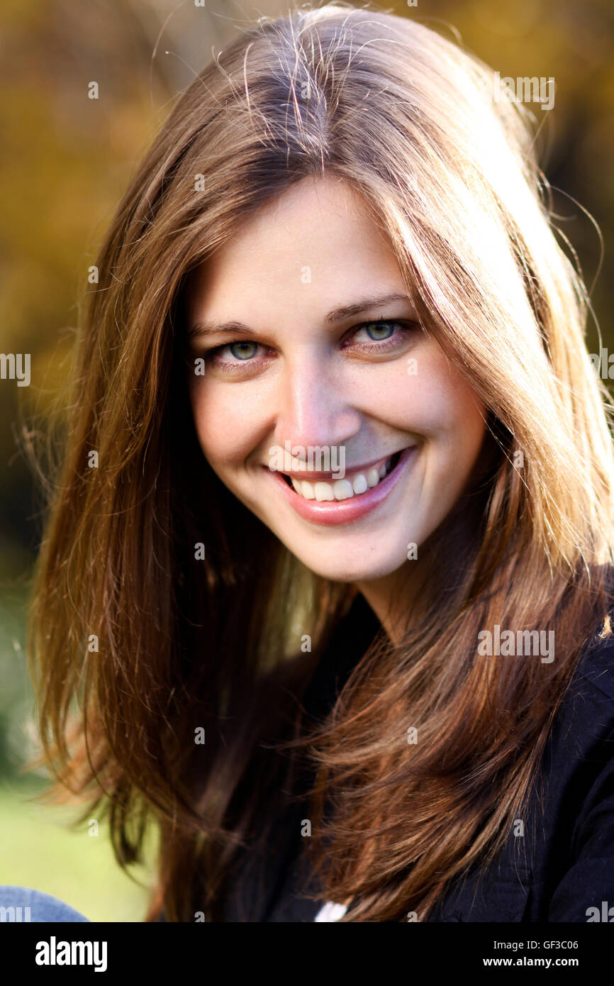 Beautiful young woman in autumn park Stock Photo - Alamy