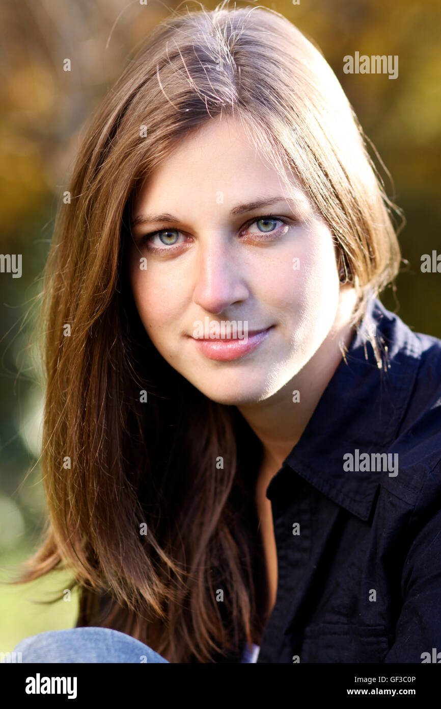 Beautiful young woman in autumn park Stock Photo - Alamy
