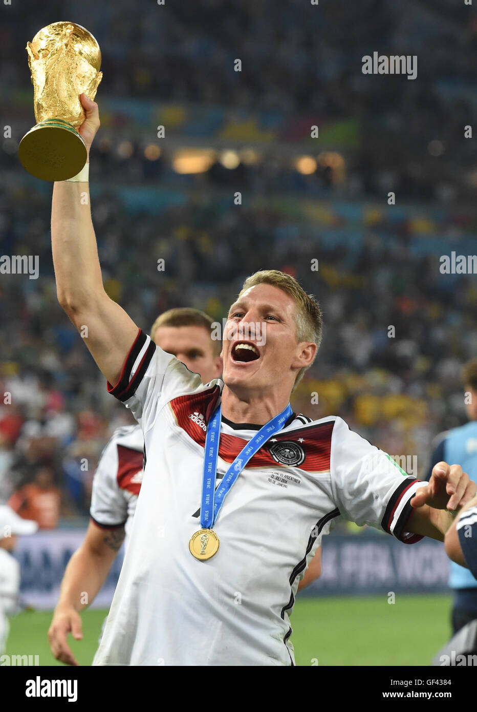 Rio de Janeiro, Brazil. 13th July, 2014. Bastian Schweinsteiger of Germany poses with the World Cup trophy after winning the FIFA World Cup 2014 final soccer match between Germany and Argentina at the Estadio do Maracana in Rio de Janeiro, Brazil, 13 July 2014. Photo: Andreas Gebert/dpa/Alamy Live News Stock Photo