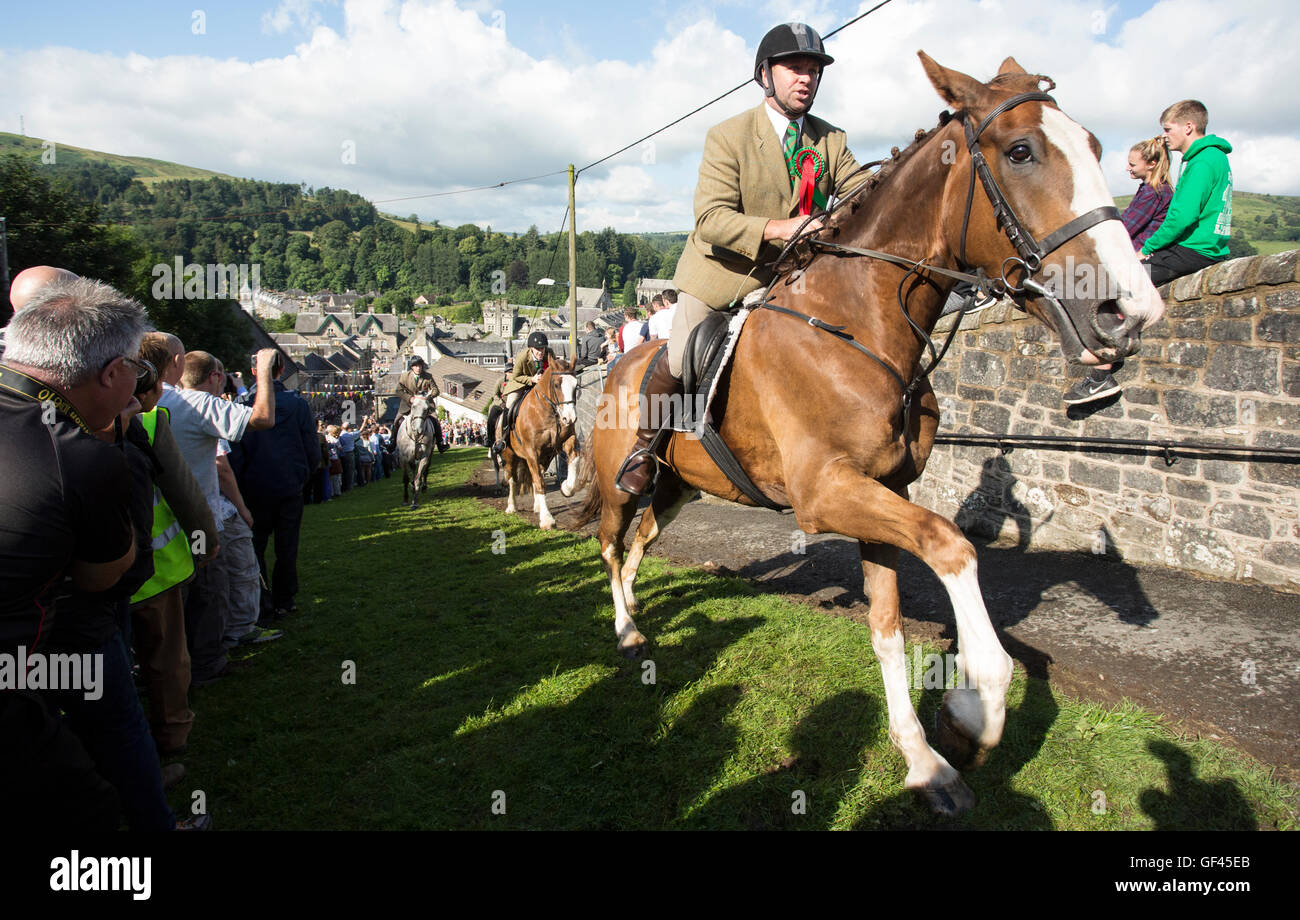 Horses charging up Kirk Wynd, Langholm Common Riding, Langholm, Scotland UK Stock Photo