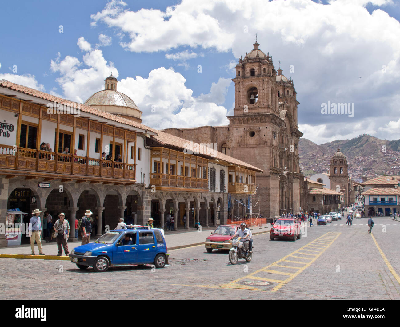The modern shops and  Cuzco Church on Plaza de Armas Stock Photo