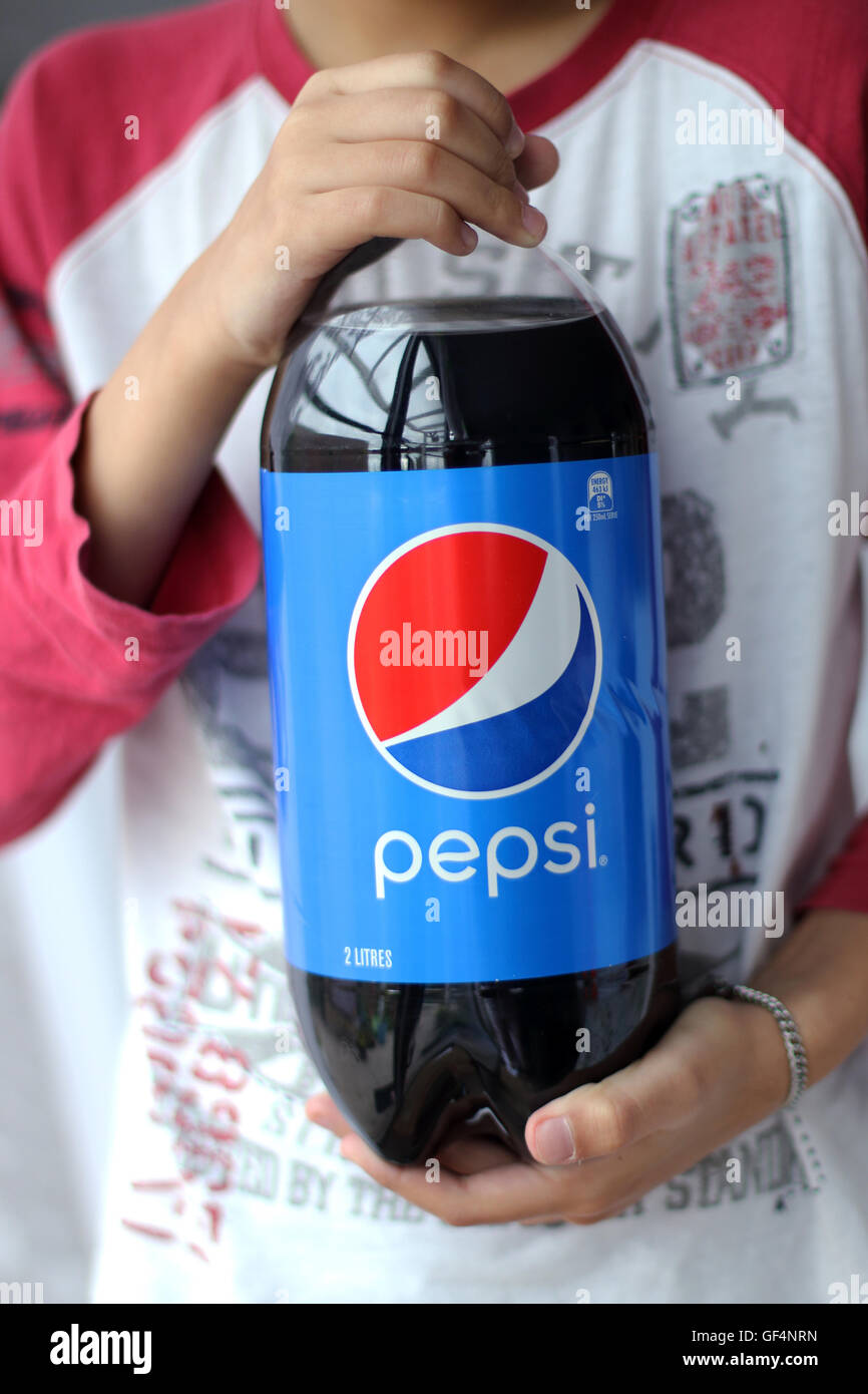 A child holding Pepsi soft drink Stock Photo