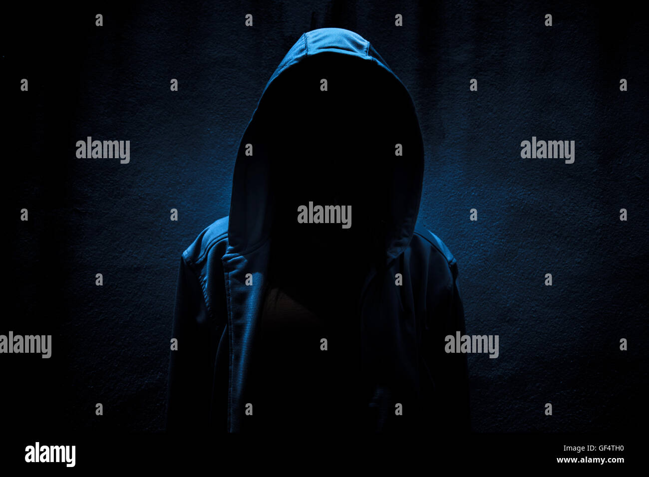 Woman wearing hoodie hiding in the dark,Scary background for book cover