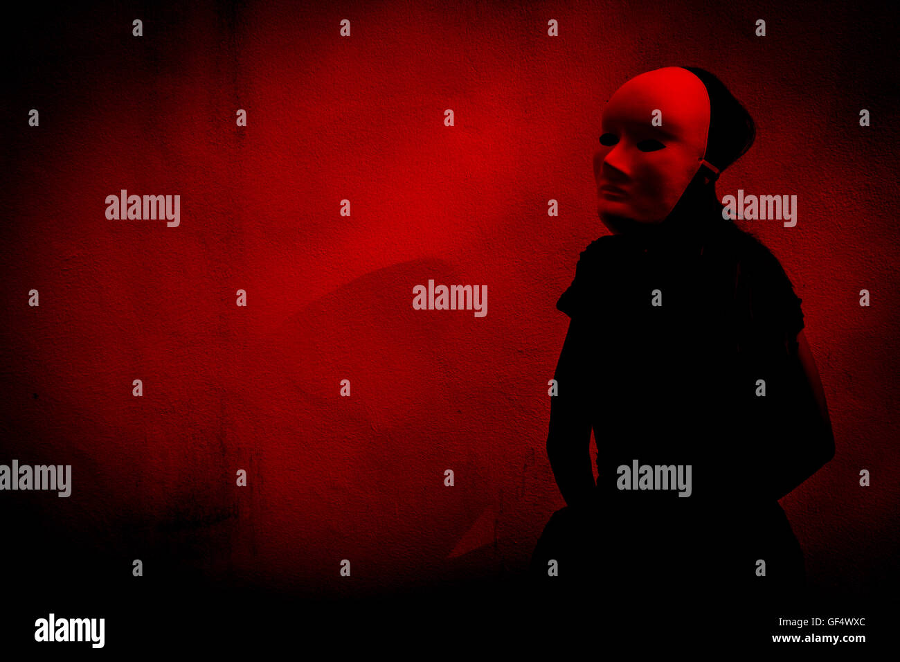 Mysterious woman in black dress wearing white mask,Scary background for