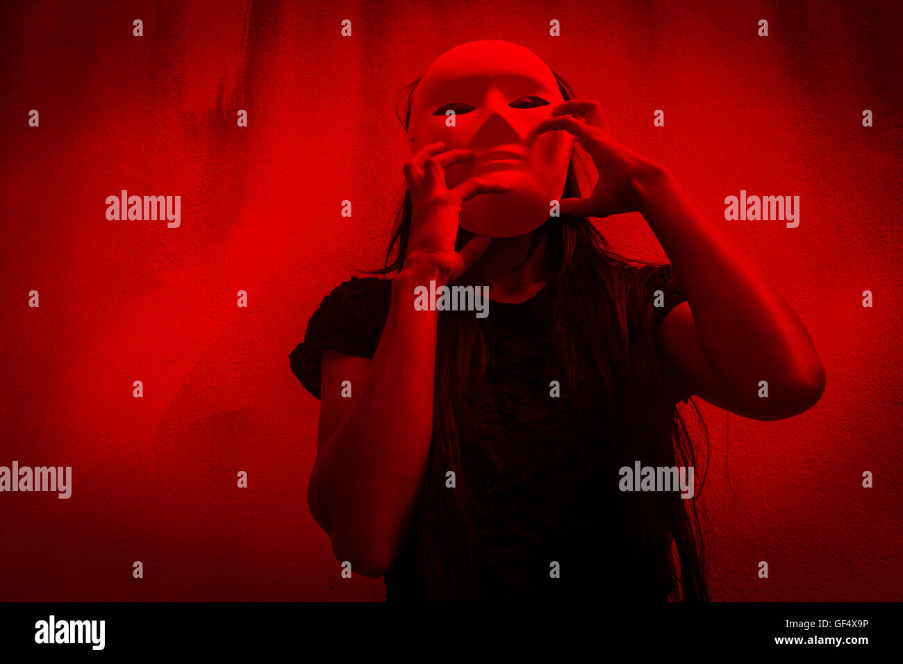 Mysterious woman in black dress wearing white mask,Scary background for