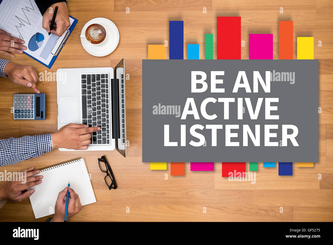 BE AN ACTIVE LISTENER Business team hands at work with financial reports and a laptop Stock Photo