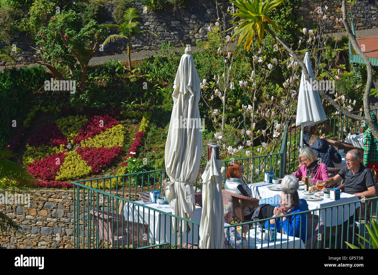 People sitting in cafe by gardens at Monte near Funchal, Madeira, Portugal Stock Photo