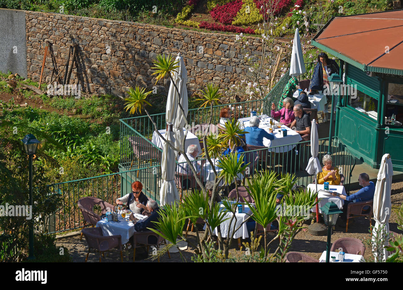 People sitting in cafe by gardens at Monte near Funchal, Madeira, Portugal Stock Photo