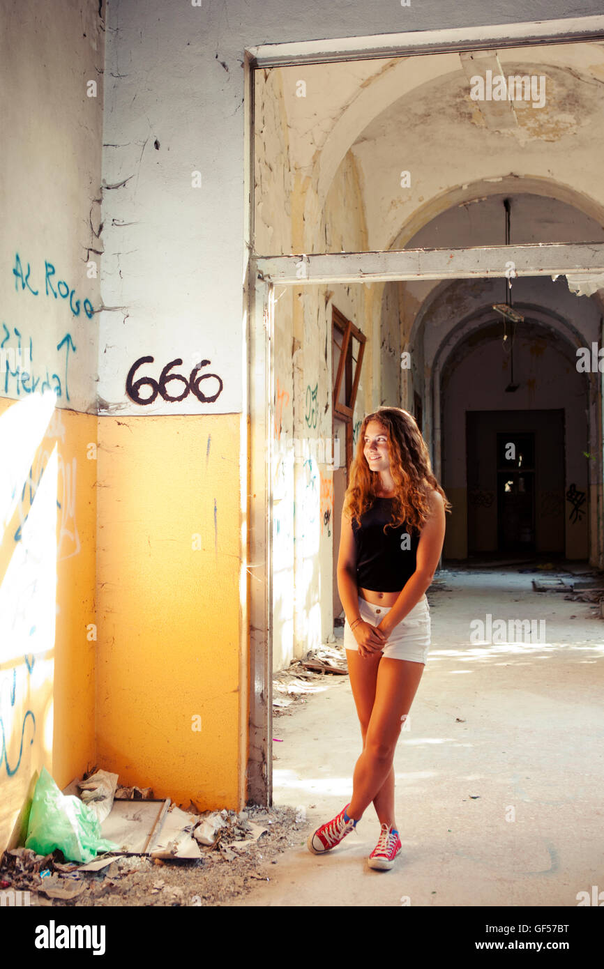 PORTRAIT OF A YOUNG TEENAGER IN A DERELICT SANATORIUM Stock Photo