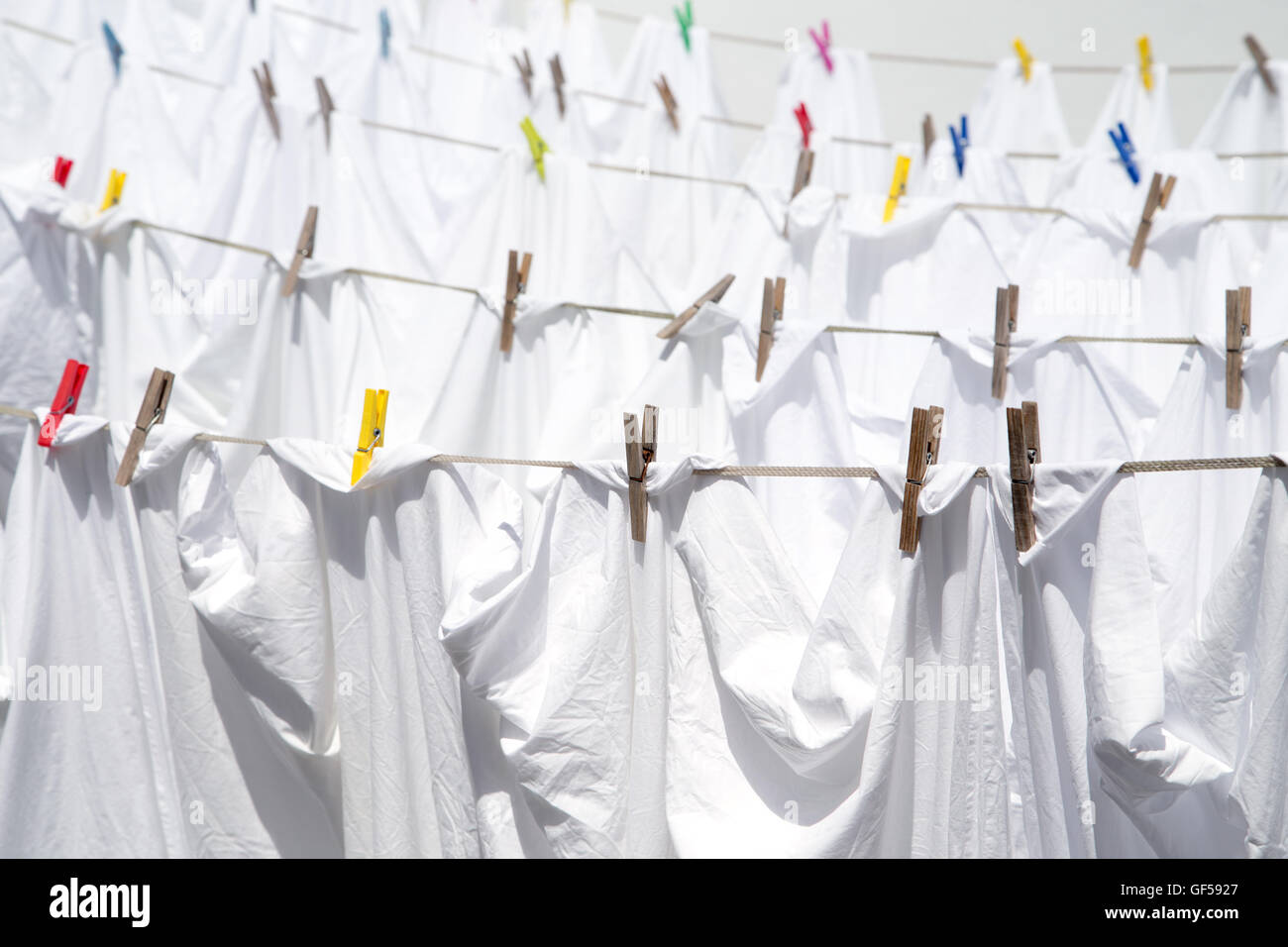 White sheets drying in the sun Stock Photo