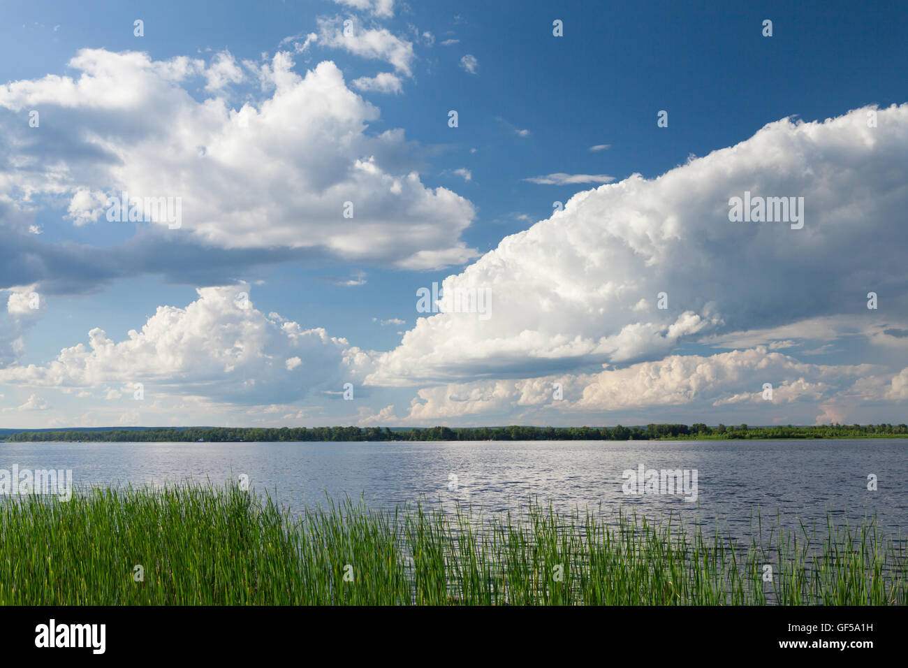 Landscape with river and cloudy sky. Sunny summer scene Stock Photo - Alamy