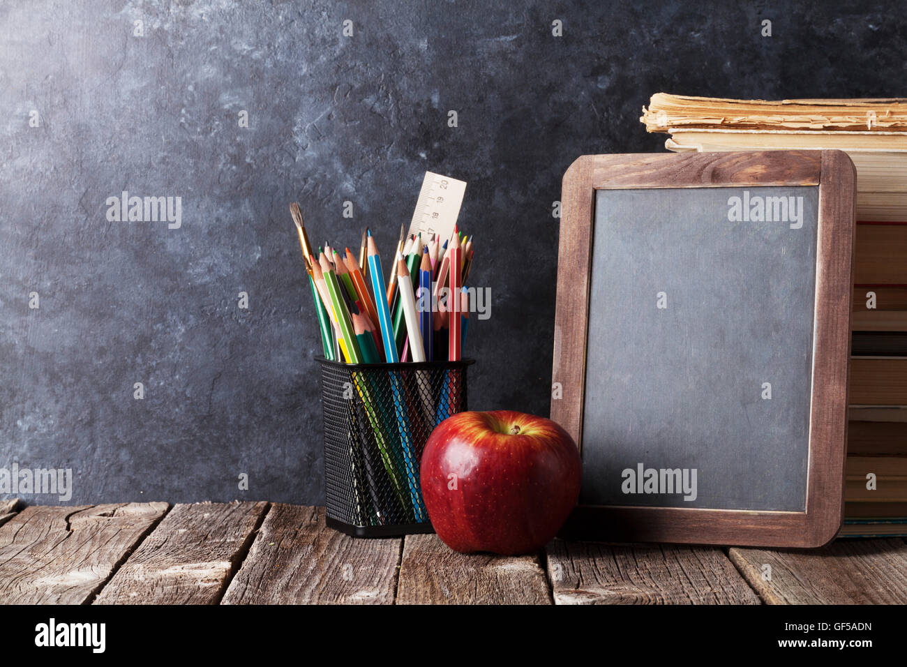 Education or back to school Concept. glasses, pencils, note books, chalk,  eraser over chalkboard background. Stock Photo