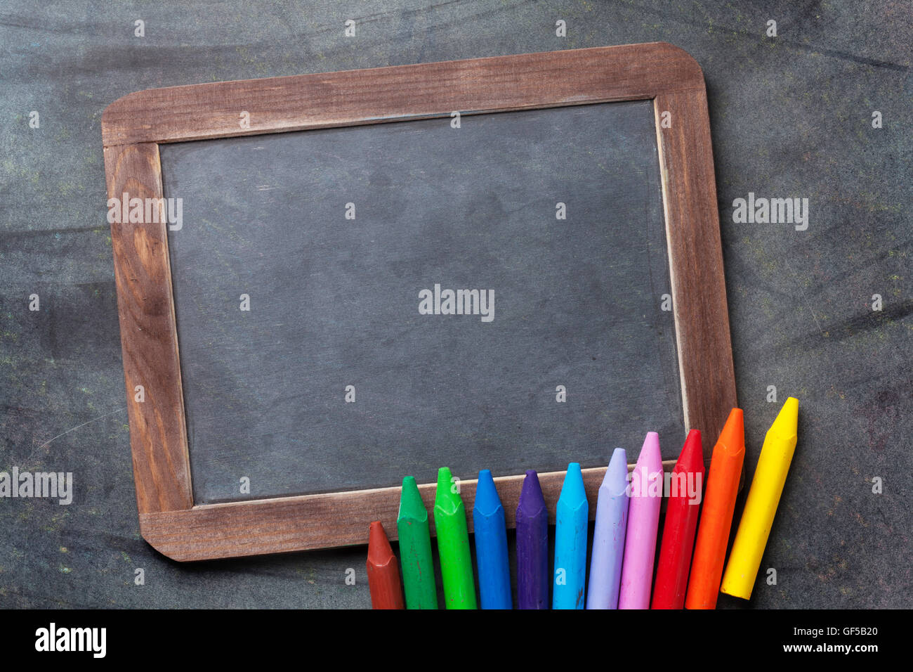 Chalkboard for your text and colorful chalks. Back to school concept ...