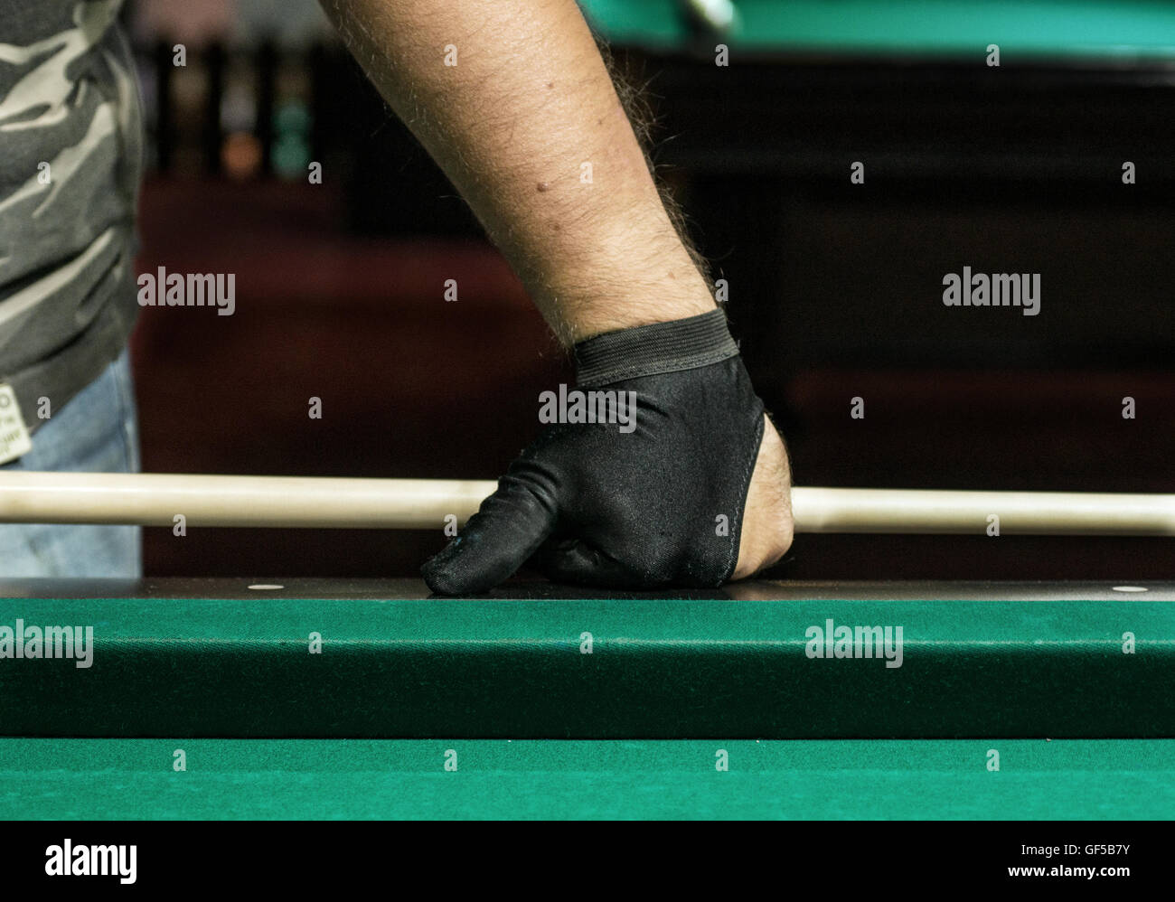 A pool player hand in a glove pressed upon a table Stock Photo - Alamy