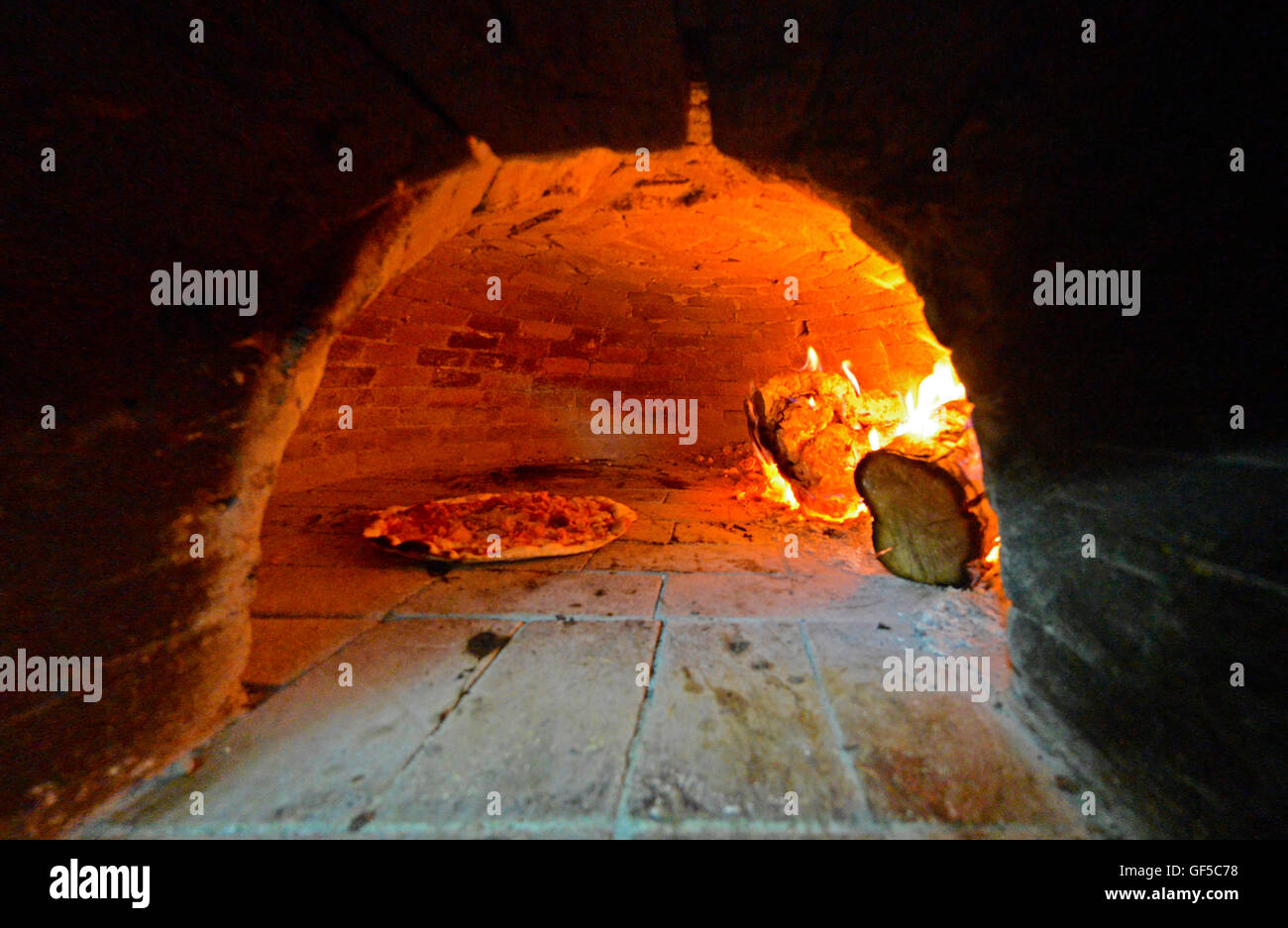 Pizza in traditional stone oven Stock Photo Alamy