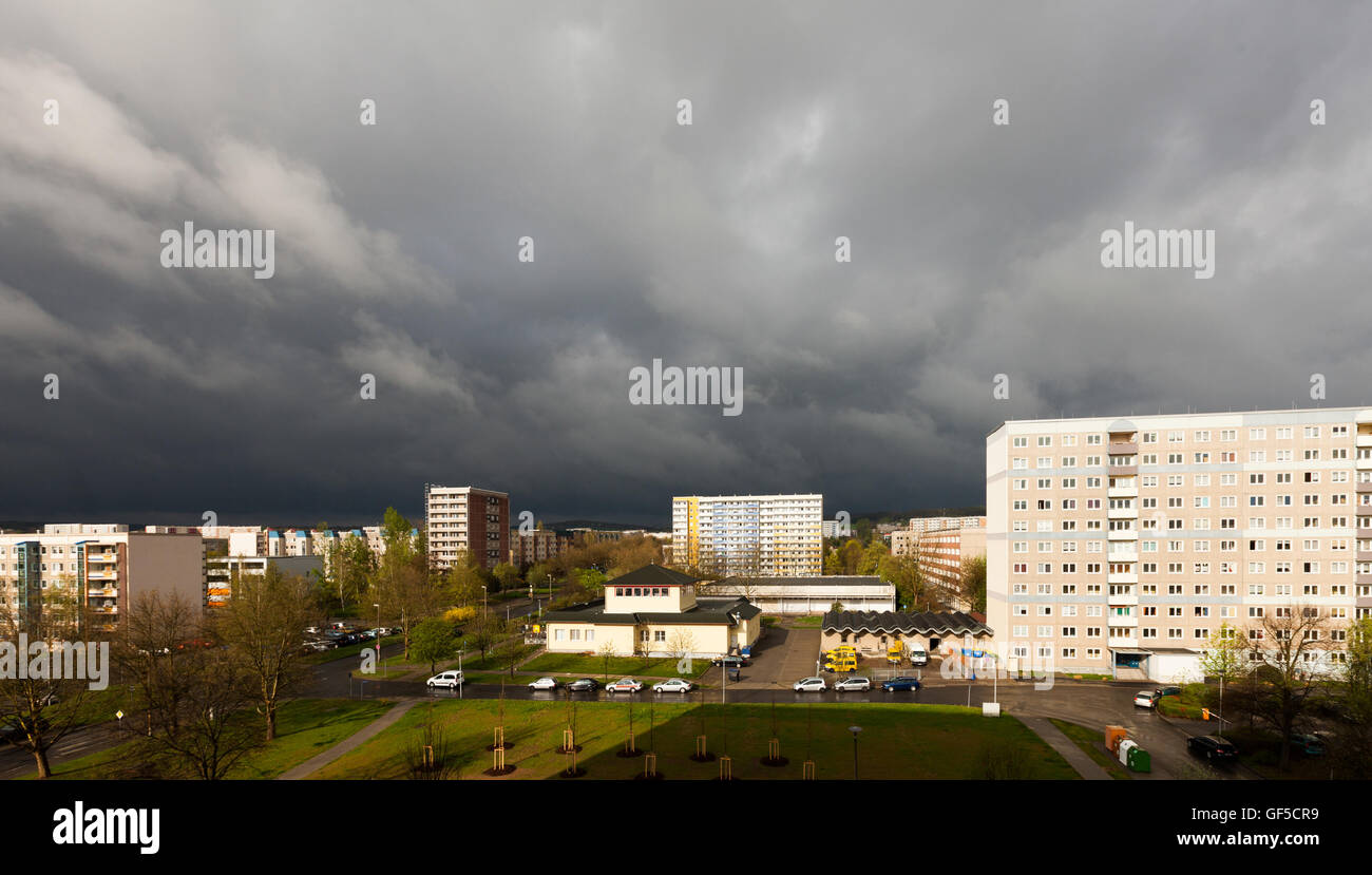 City on a sunny day with black clouds Stock Photo